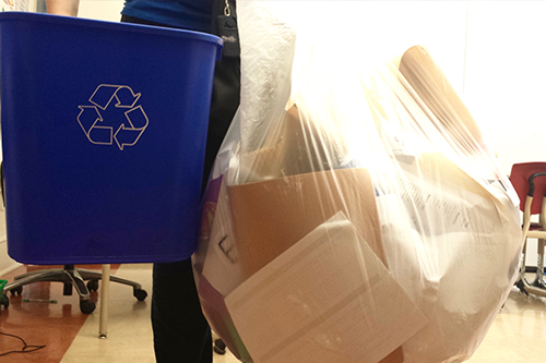 Paper recycling bin and a bag of collected paper 